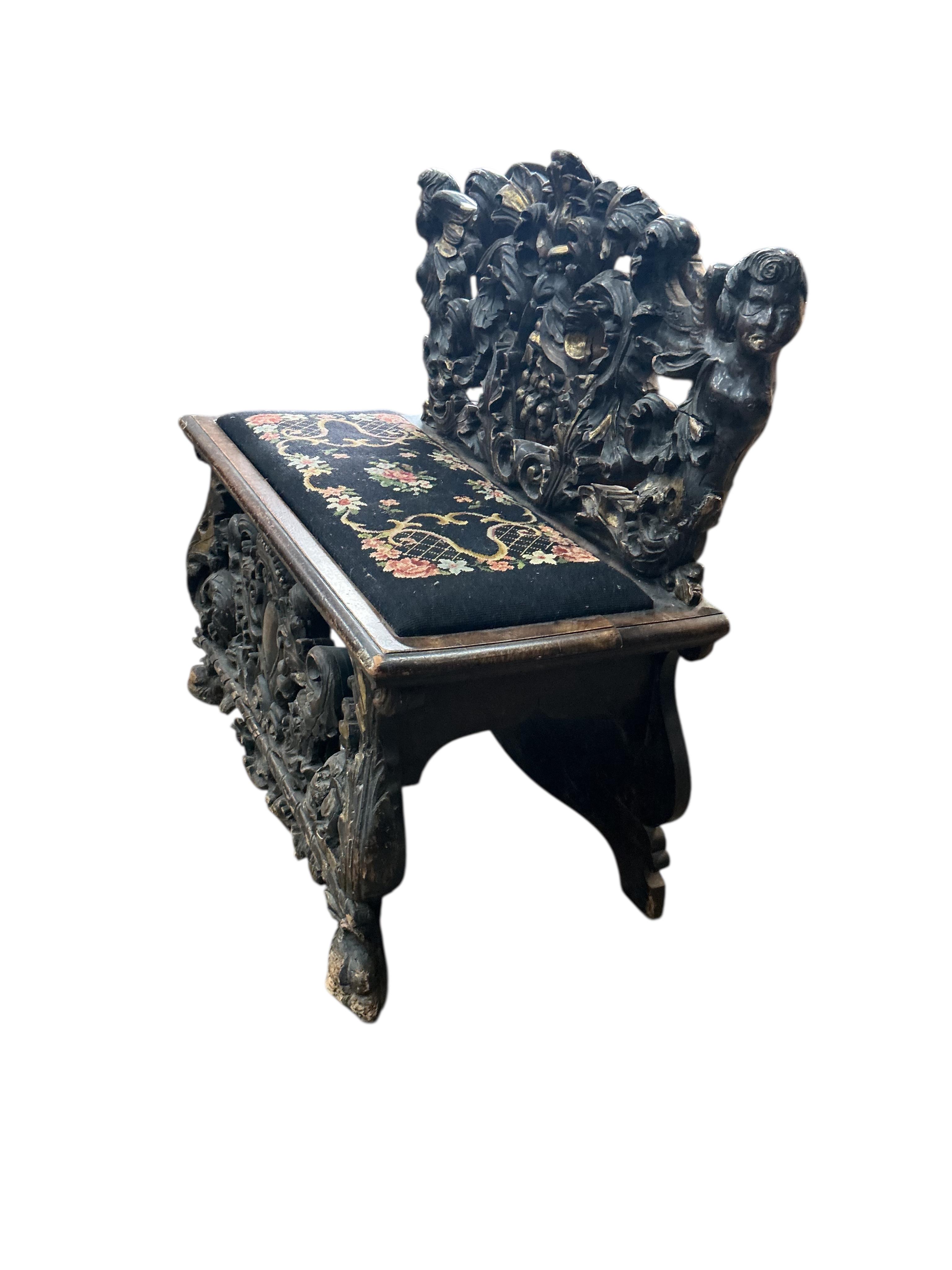 A 19th century Italian giltwood and later painted carved bench, width 95cm, depth 46cm, height 92cm
